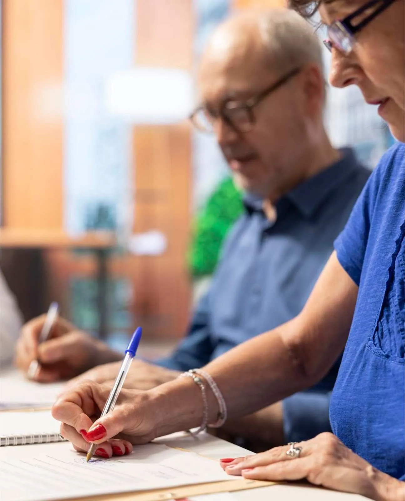 Two people going through Medicare paperwork together