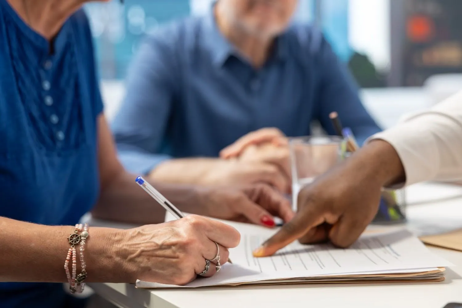 A Medicare conversation over coverage papers at a kitchen table